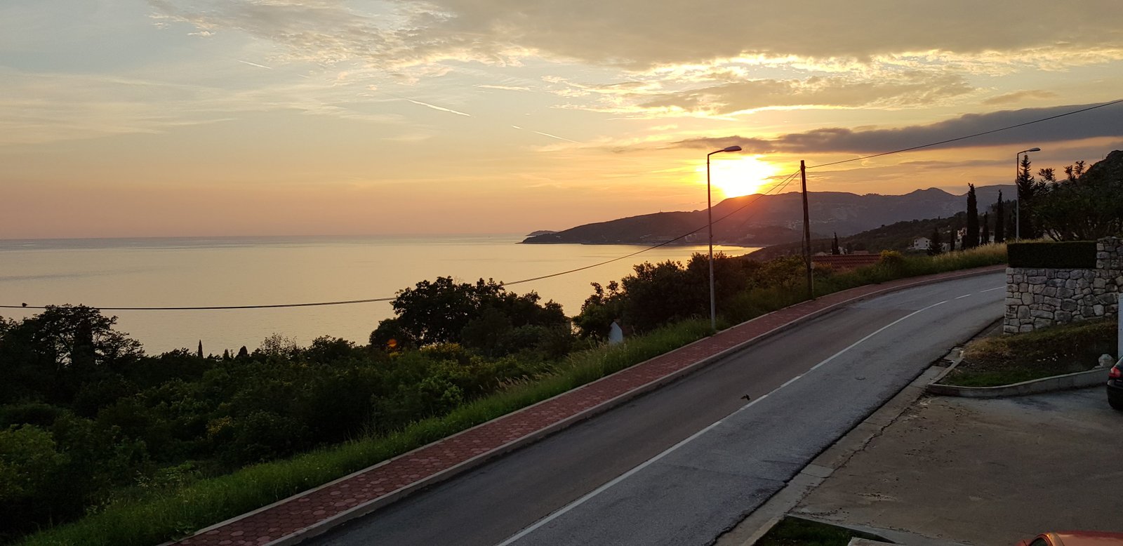 Sunset over a winding coastal road