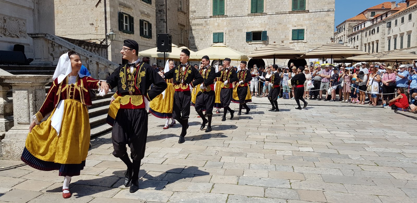 Traditional dancers performing in a historic square