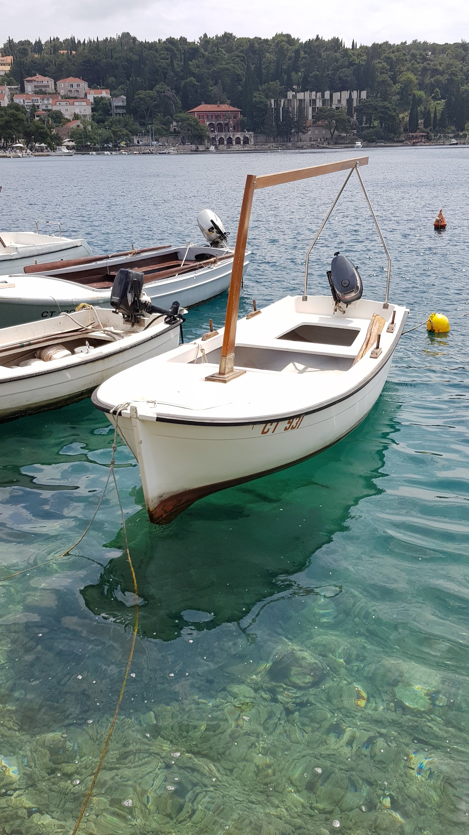 Boats moored in clear turquoise water
