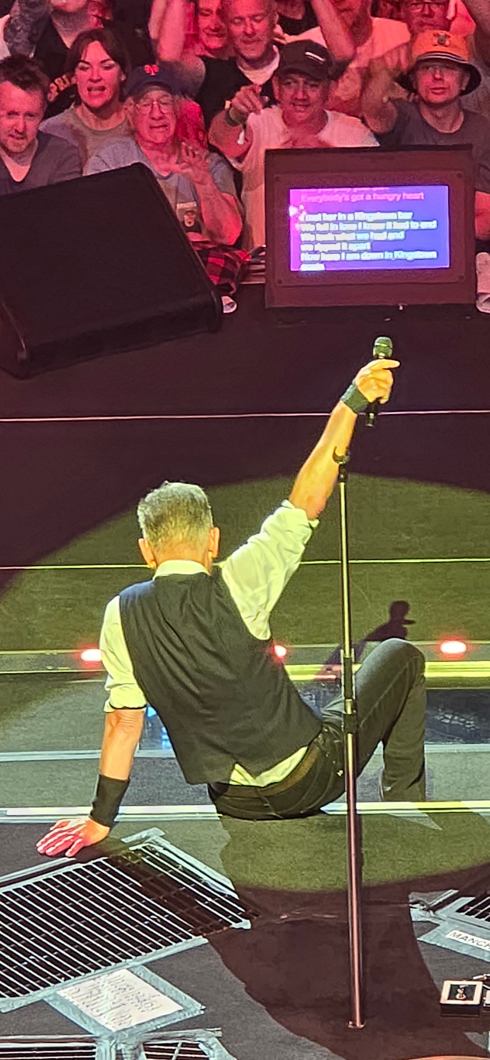 Bruce Springsteen on stage with audience and lights